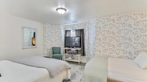 a bedroom with two beds and a flat screen tv at Play & Gather in Luxury,Pets too! Close to it Everything! in Orem