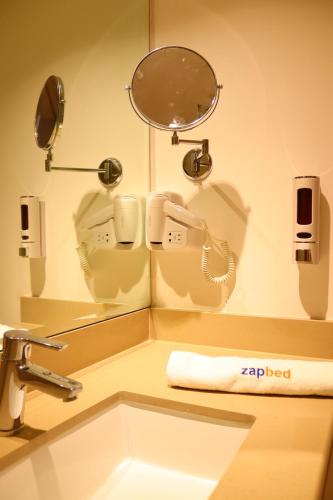 a bathroom with a sink and a mirror at ZAPBED House - Luxury Holiday Homes in Yas Island in Abu Dhabi