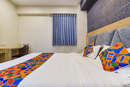 a bedroom with a large white bed with colorful pillows at Hotel Canada in Vastral