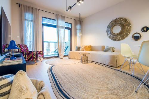 a bedroom with a bed and a living room at Burj Al Arab View - 1BR in MJL Lamtara 1- Sea View 703 in Dubai