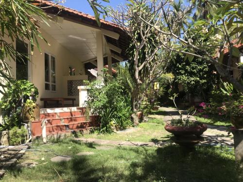 a garden in front of a house at Nhat Quang Bungalow in Mui Ne