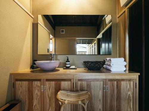 a bathroom with a sink and a mirror at RITA Yame Fukushima in Yame