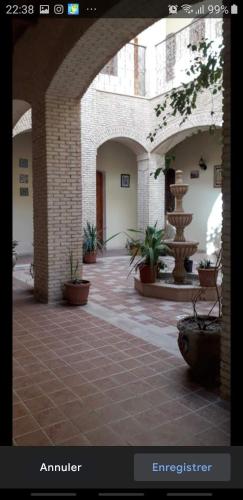 a picture of a courtyard with a fountain in a building at Residence Tozeur Almadina in Tozeur