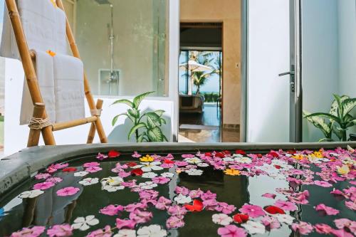 a pond filled with flowers in a room at Sonata Resort & Spa in Phan Thiet