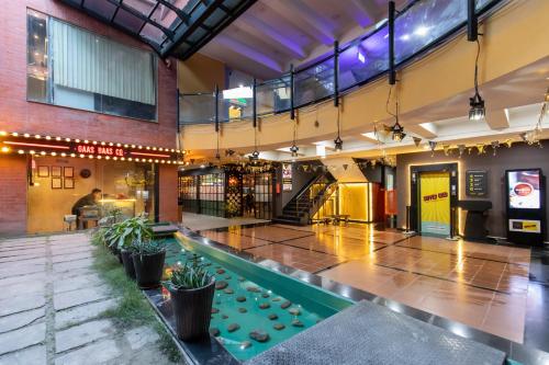 a large building with a pool in the middle at Gaas BaasCo in Kathmandu