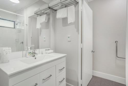 a white bathroom with a sink and a shower at Capital Lodge Motor Inn in Wellington