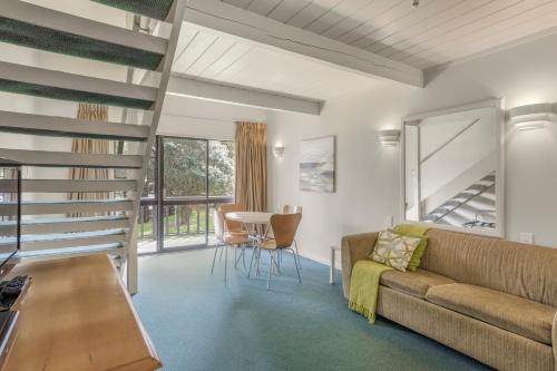 a living room with a couch and a table at Capital Lodge Motor Inn in Wellington