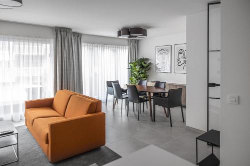 a living room with a couch and a table at Casselbergh Residences Petunia - De Haan in De Haan