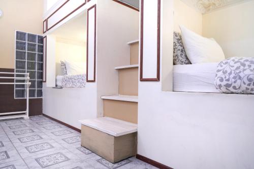 a small bedroom with a bed and a window at Guesthouse Phuket Airport in Ban Bo Han
