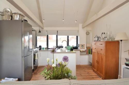 a large kitchen with a couch in a room at Contractor and Family friendly Grade II townhouse- 3 bedrooms- free parking in Norwich