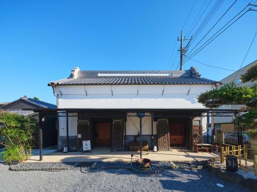 a building with a dog sitting in front of it at Itako Shimagen -潮来の古民家 島源- in Itako