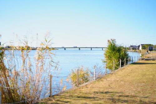 a body of water with a bridge in the background at Itako Shimagen -潮来の古民家 島源- in Itako
