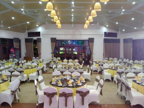 a banquet hall with tables and chairs in a room at Sonata Resort & Spa in Phan Thiet