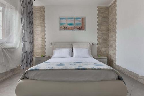 a bedroom with a large bed in a room at Appartamento Greco by BarbarHouse in Borgagne