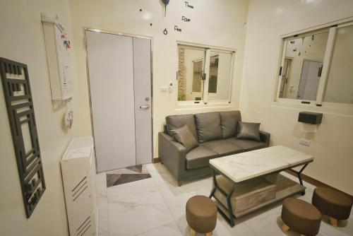 a living room with a couch and a table at 寮寓x綺澄 in Xiaoliuqiu