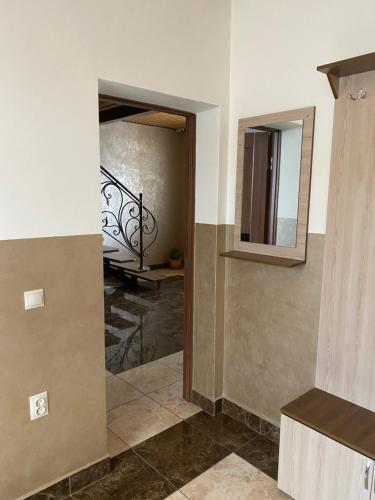 a hallway with a staircase and a mirror on the wall at Домашній Затишок in Stryi