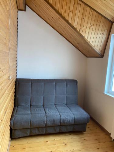 a couch sitting in the corner of a room at Домашній Затишок in Stryi