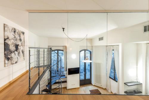 a glass wall in a room with a staircase at Milan Retreats Navigli in Milan