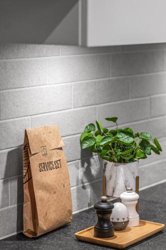 a paper bag sitting on a counter with a plant at Milano Ostend - Casselbergh Residences in Ostend