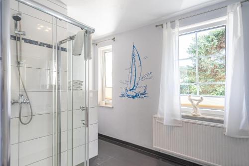a bathroom with a shower and a window at Pension Bergen in Bergen auf Rügen