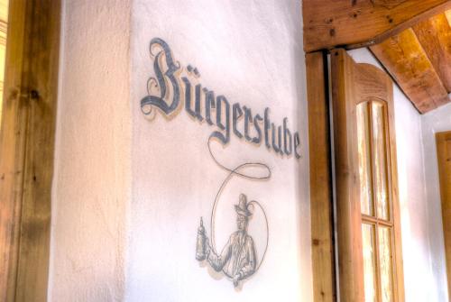 a sign on a wall with a lobster on it at Hotel Hölzer Bräu by Lehmann Hotels in Ebersberg
