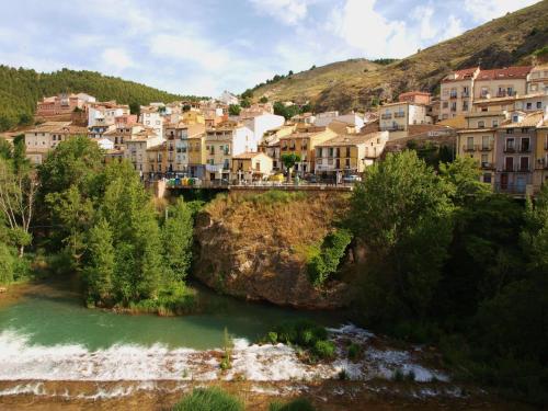 a small town with a river and a bridge at Hostal de la Luz in Cuenca