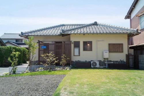 a small house with a yard in front of it at Jikukan Enishi in Taisha