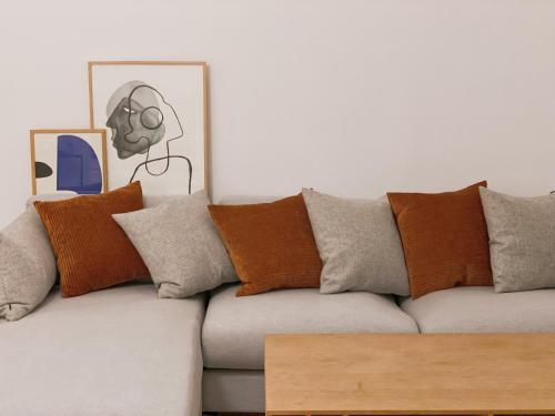 a living room with a couch with pillows and a table at An cosy apartment near CPH airport in Copenhagen