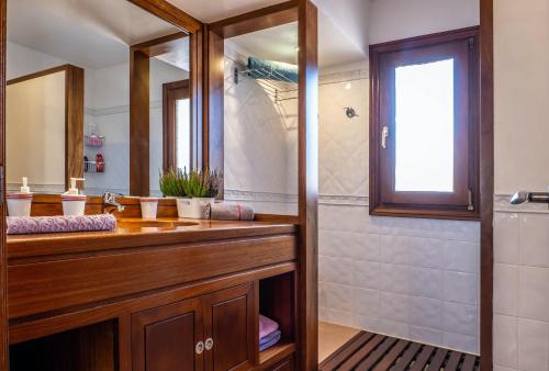 a bathroom with a wooden sink and a shower at Elegant Villa in Ciutadella de Menorca with Private Pool in Sa Caleta