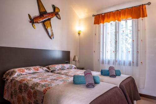 a bedroom with two beds with slippers on them at Elegant Villa in Ciutadella de Menorca with Private Pool in Sa Caleta