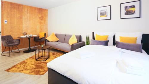 a bedroom with a large bed and a couch at Chic Studio : Super Zentral : 1min zum HBF in Mannheim