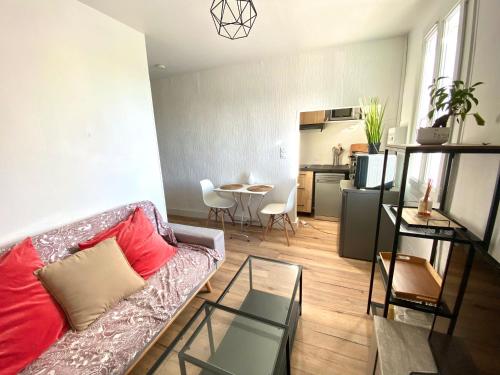 un salon avec un canapé et une table dans l'établissement Appartement cozy, à Montpellier
