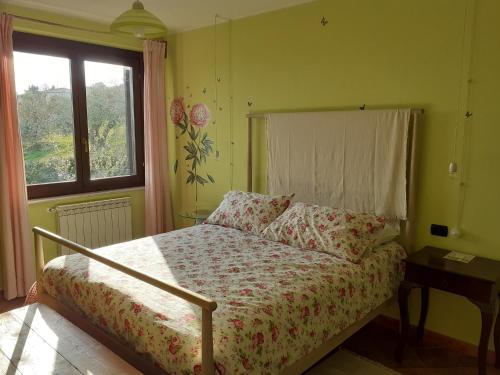 a bedroom with a bed and a window at VILLETTA TRA GLI ULIVI in Citta' Sant'Angelo