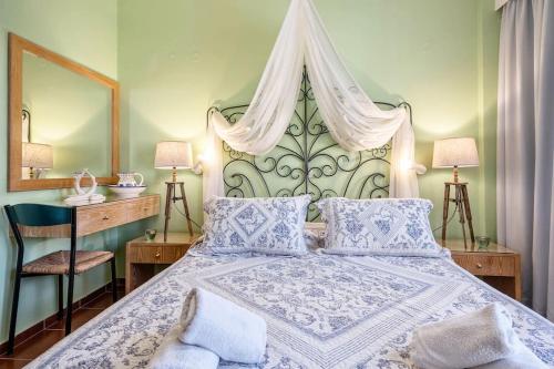 a bedroom with a large bed with a canopy at Calergi Residence - Holidays in Crete in Atsipopoulo