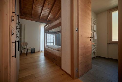 a bedroom with a bed and a door to a room at Ostello Scudellate by Stay Generous in Scudellate