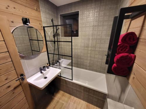 a bathroom with a sink and a bath tub at Hillview Jasná Chalet in Demanovska Dolina