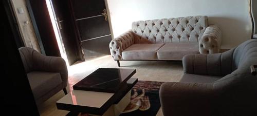 a living room with two couches and a coffee table at Remarkable 2-Bed Apartment in Asaba in Asaba