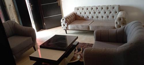 a living room with two couches and a coffee table at Remarkable 2-Bed Apartment in Asaba in Asaba