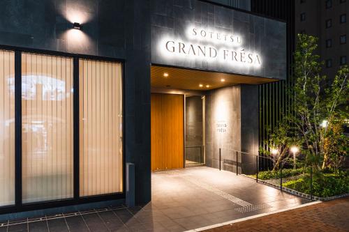 a building with a sign that reads secret grand first at Sotetsu Grand Fresa Kumamoto in Kumamoto