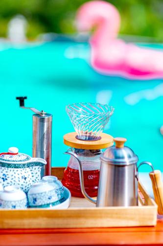 a tray with a tea pot and a juicer at Chateau de Luxi Khao Yai - ชาโตว์ เดอ ลูซี่ เขาใหญ่ in Mu Si
