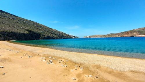 a group of footprints in the sand on a beach at Homa Serifos pool villas in Serifos Chora