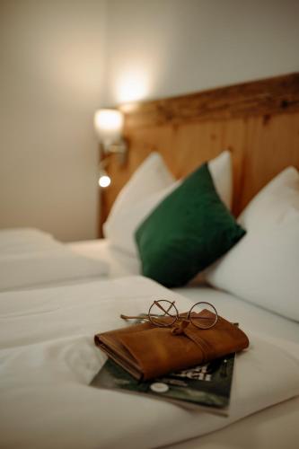 a pair of glasses on a tray on a bed at Appartement Wiederkehr in Flachau