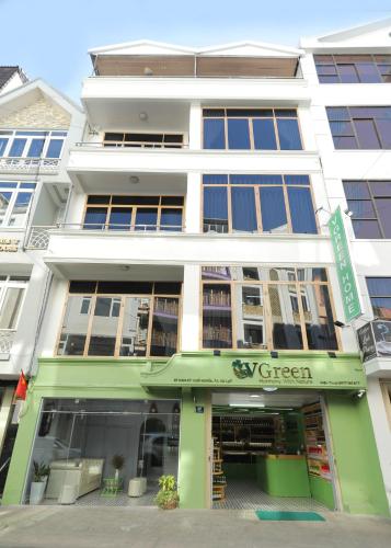 a green and white building with a store at Vgreen Home in Da Lat