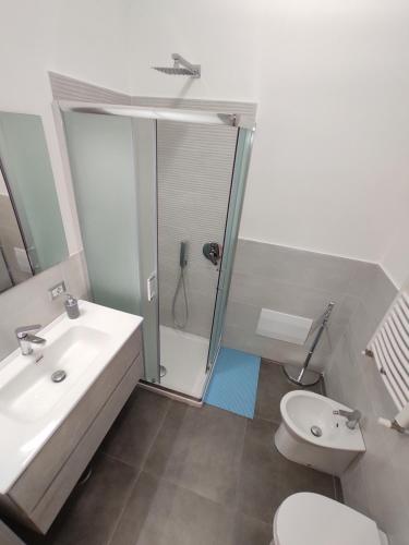 a bathroom with a shower and a toilet and a sink at Apartment NAPOLI MARADONA in Naples