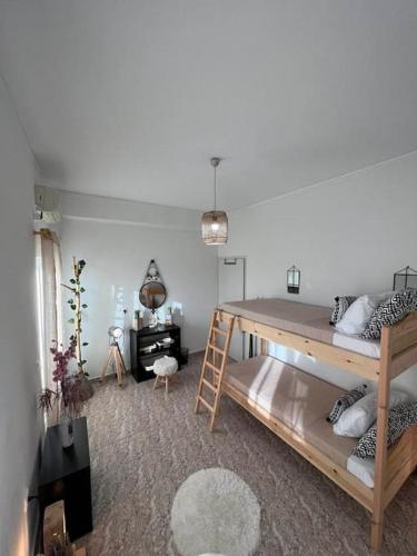 a room with two bunk beds and a desk at Beach apartment Edem first floor in Perivolos