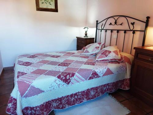 a bedroom with a bed with a quilt on it at Panchita in Garafía