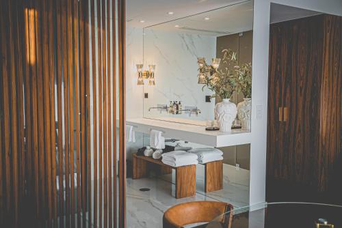 a bathroom with a sink and a table with towels at Quinta de Silvalde in Santo Tirso