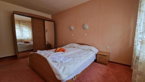 a bedroom with a bed with a stuffed animal on it at Apartment 24 in Pamporovo