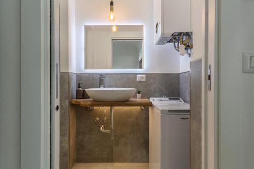 a bathroom with a sink and a mirror at Casa Melo Mini House in Bologna