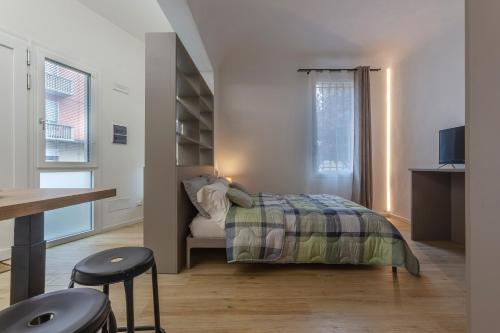 1 dormitorio con cama, escritorio y ventana en Casa Melo Mini House en Bolonia